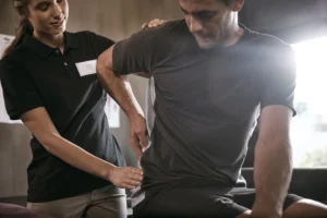 Man receiving aid for back pain